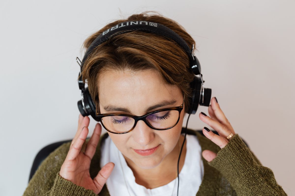 A woman enjoys music on her headphones