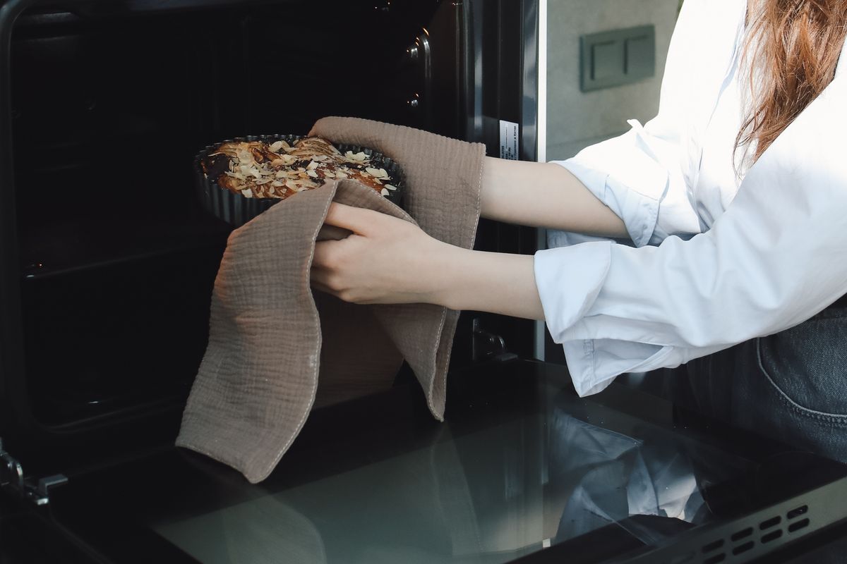 Taking a fresh-baked dish out of the oven