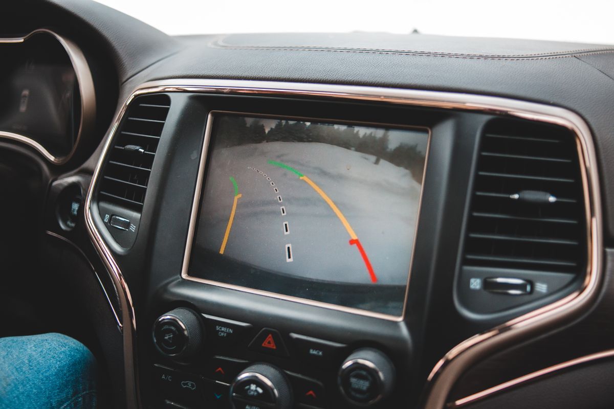 A car dashboard screen showing the backup camera view