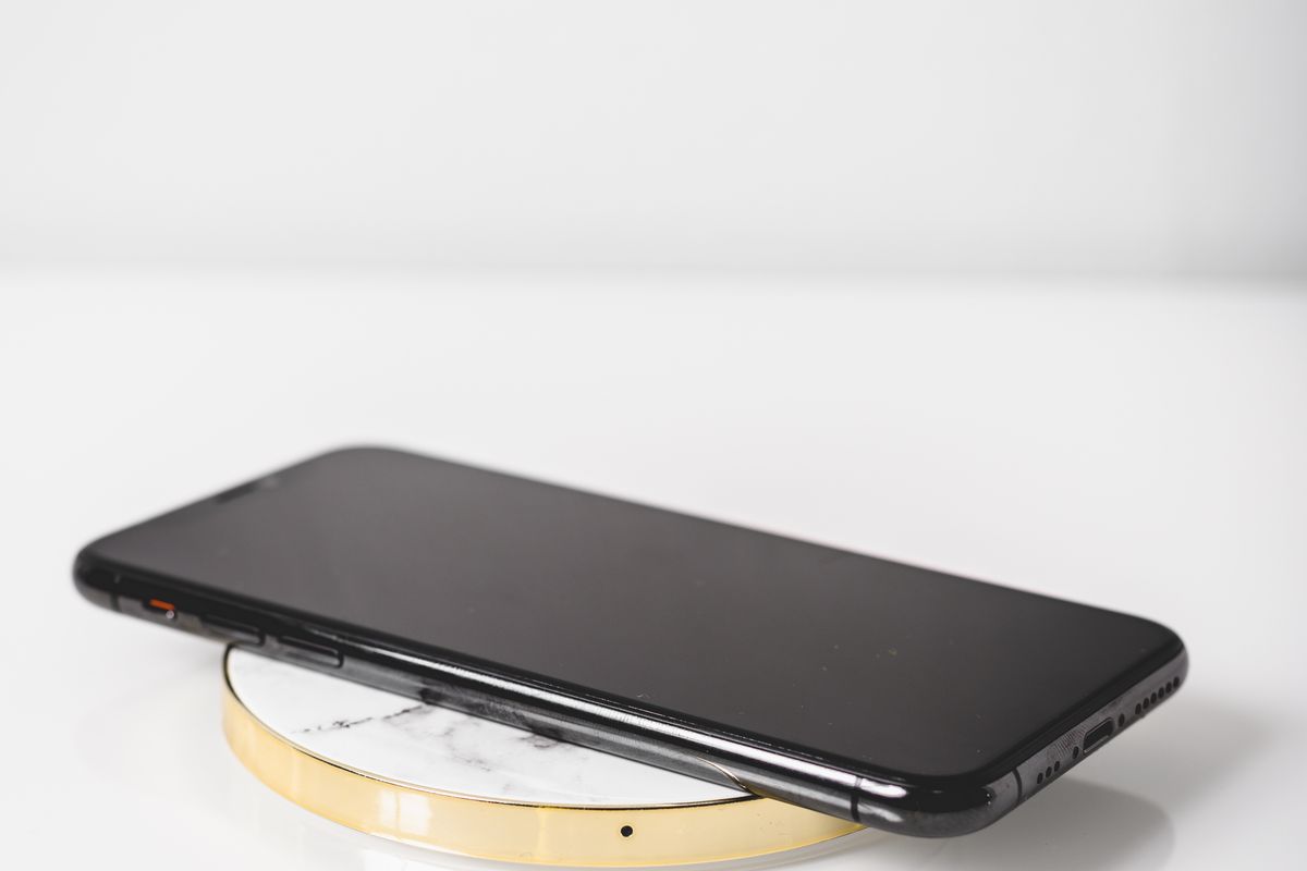 A phone charging on a marble wireless charging pad